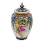 A Royal Worcester lidded vase, with pierced lid, decorated with colourful flowers with gilt