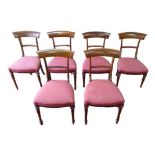 A set of six Edwardian rosewood bar back dining chairs, with red upholstered seats, turned