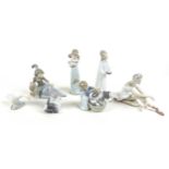 A collection of Lladro and Nao figurines, comprising 'Cat and Mouse', boxed, 'Don't Forget Me',