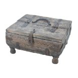 An 19th century oak lidded case, with naive carved decoration, cast metal fittings and raised upon