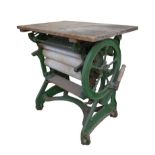A Victorian mangle, with pale green painted cast iron frame and pine washboard, 75.5 by 50 by 81cm