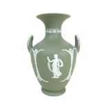 A Wedgwood Jasperware dip green vase, of baluster form with twin handles, decorated with female