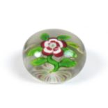A Baccarat paperweight, mid/late 19th century, clear glass with white and red primrose with bud on