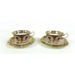 Two Royal Crown Derby bone china trios, decorated in Imari, 1128, pattern, each comprising a cup, 10