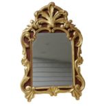 A 19th century giltwood framed mirror with later looking glass, the frame with decorative foliate