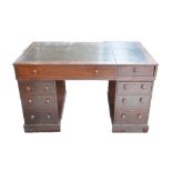 A Victorian mahogany pedestal desk, with seven short and one long drawer, all with bun handles,