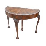 An Edwardian mahogany demi-lune card table, green baize top, ball and claw feet, 104 by 53 by 77cm