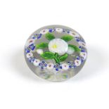 A Baccarat paperweight, 19th century, with central white flower on green stem, with an outer garland