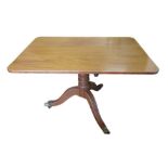 An Edwardian mahogany breakfast table, with rectangular top and tripod base with reeded legs and