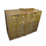 An Art Deco walnut veneered sideboard, the breakfront with two frieze drawers with circular bakelite