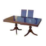 A reproduction twin pedestal dining table, with two additional leaves, draw action, 179 by 110 by