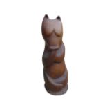 A carved wooden doorstop modelled as a bear