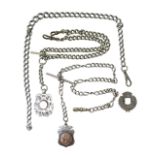 A group of silver Albert fob chains, some with medallion fobs attached.