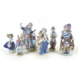 A collection of six Lladro figurines, five modelled as clowns, one as a girl with a basket, together