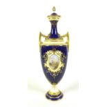 A Coalport twin handled covered vase, cobalt blue ground, overlaid with raised gilding, and a