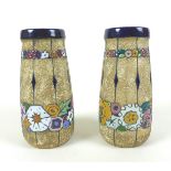 A pair of 20th century Amphora vases, decorated with colourful flowers, impressed marks to the