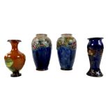 A group of four Doulton Lambeth stoneware vases, comprising a pair decorated with fruit and blue