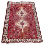 A small Persian rug, with geometric decoration, 127 by 81cm.