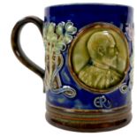 A Royal Doulton stoneware Royal Commemorative mug, circa 1901, decorated in Art Nouveau taste with a