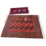 A Tekke rug with orange / red ground, two rows of five dark blue guls, 257 by 173cm, together with a