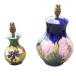 Two Moorcroft table lamps, comprising a large magnolia pattern lamp, 17.5 by 31cm overall,