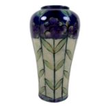 A Royal Doulton stoneware slip cast vase, circa 1912, decorated with stylised tall purple flowers
