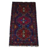 A new Baluchi rug, with blue ground with three central polygons, encased in a repeating floral