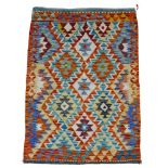 A Chobi Kilim vegetable dye rug, with orange ground and diamond pattern, 112 by 82 cm.