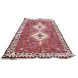 A group of three rugs, comprising a Tekke rug with red ground