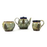 A Royal Doulton stoneware matched three piece tea service, circa 1900, decorated in Art Nouveau