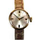 A Tissot 9ct gold lady's wristwatch, circa 1966, with circular silvered dial, gold and black baton