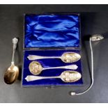 A group of silver servicing spoons, comprising a set of two berry spoon and matching sugar sifter,