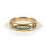 An 18ct gold and diamond quarter eternity ring, with seven round brilliant cut diamonds, size K, 4.