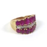 A 9ct gold, ruby and diamond dress ring, formed of two rows of graduated oval cut rubies, 14