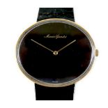 A Maurice Guerdat gold plated lady's dress watch, minimalist oval black dial, gold hands, quartz