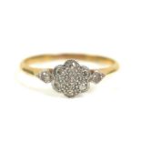 An 18ct gold daisy set diamond ring, size O, 2g,