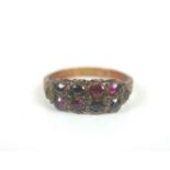 A Victorian 15ct gold ring with mixed stones, including amethysts, garnets and emeralds, with a