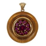 An 18ct gold and ruby pendant, a circular setting with large round cut ruby, 6.8mm, surrounded by