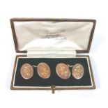 A pair of Edwardian 9ct gold cufflinks, of oval form with chain links, monogram and year engraved,