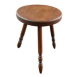 An oak milking stool, tripod base with turned legs, 33 by 36cm high.