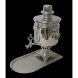 A late 19th/early 20th century silver plated Samovar, 26 by 34 by 45cm high, and a tray, 44.5 by