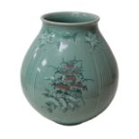 An Oriental celadon baluster form vase, 20th century, decorated with floral sprays, four character