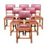 A set of six oak dining chairs, mid 20th century, with burgundy leatherette seats and backs,