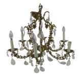 A six branch brass chandelier, late 20th century, with cut glass drops and candle effect lights,