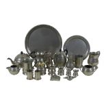 A group of pewter items, including a circular tray, tea and coffee service, tankards, and sugar
