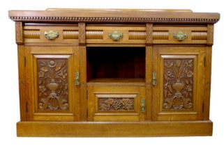 A mid 20th century oak sideboard, in Victorian style, with three drawers and two cupboards with