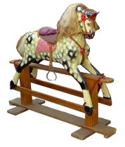 An Edwardian rocking horse, painted decoration and red leather saddle, pine base, 136.5 by 47 by