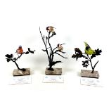 A group of three Albany Fine China ornaments, modelled as china birds on metal branches,