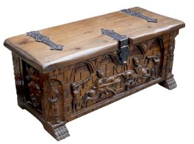 A modern dark stained pine blanket chest, carved in high relief with a Medieval jousting scene,