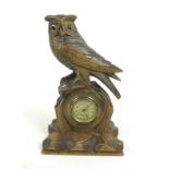 A Black Forest carved wood mantel clock in the form of an owl, mid 20th century, 27.5 by 16 by 11.